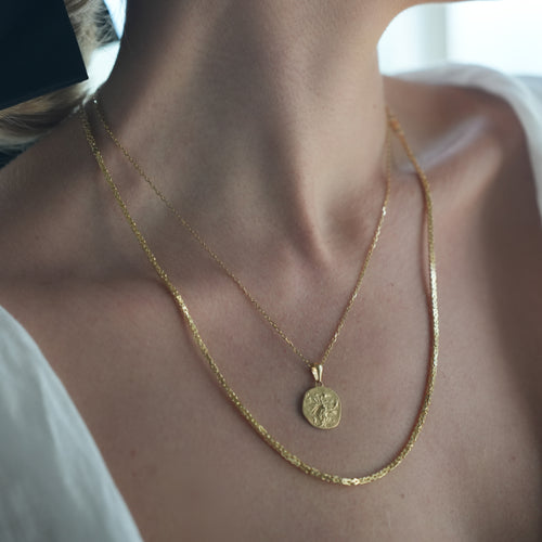 Gold necklace with medallion with the zodiac sign Taurus Le Voyage